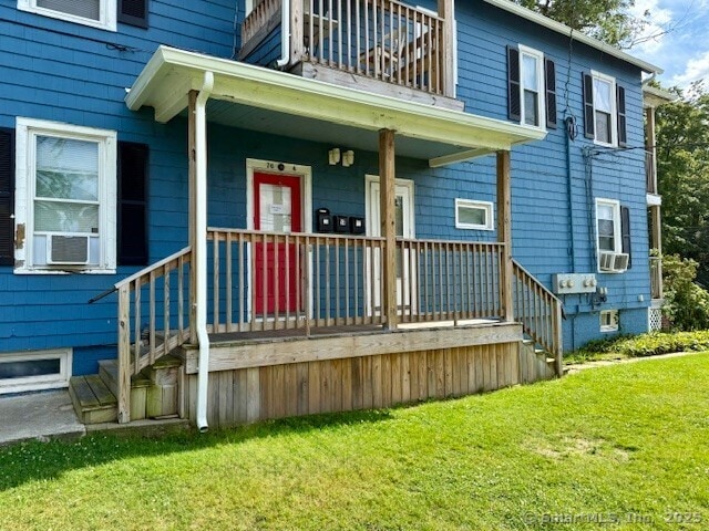 72 Stewart St, Bristol, CT 06010 - doorway to property featuring cooling unit, a lawn, and a balcony