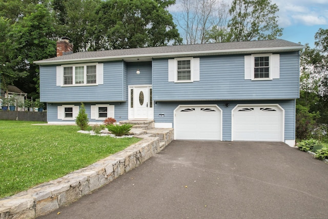 90 Haddad Rd, Waterbury, CT 06708 - split foyer home featuring an attached garage, a chimney, and asphalt driveway