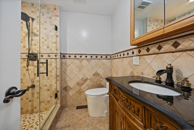 90 Haddad Rd, Waterbury, CT 06708 - bathroom with a shower stall, vanity, tile walls, tile patterned floors, and wainscoting
