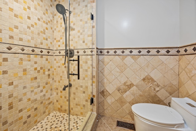90 Haddad Rd, Waterbury, CT 06708 - bathroom featuring tile walls, a stall shower, and wainscoting
