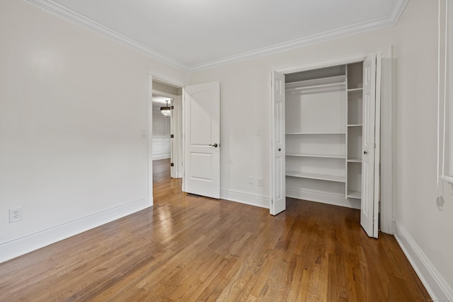90 Haddad Rd, Waterbury, CT 06708 - unfurnished bedroom with wood finished floors, ornamental molding, and a closet
