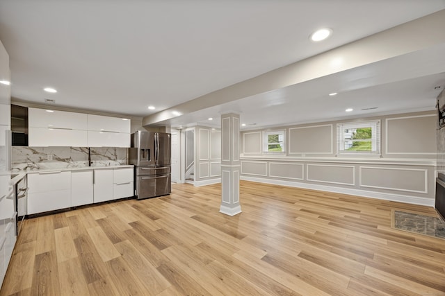 90 Haddad Rd, Waterbury, CT 06708 - below grade area featuring stainless steel refrigerator with ice dispenser, light wood-style floors, a decorative wall, and recessed lighting