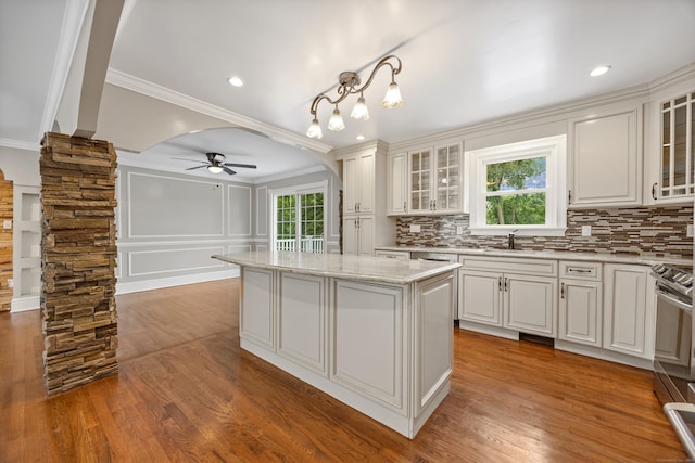 90 Haddad Rd, Waterbury, CT 06708 - kitchen featuring crown molding, ceiling fan, a kitchen island, tasteful backsplash, and stainless steel electric range