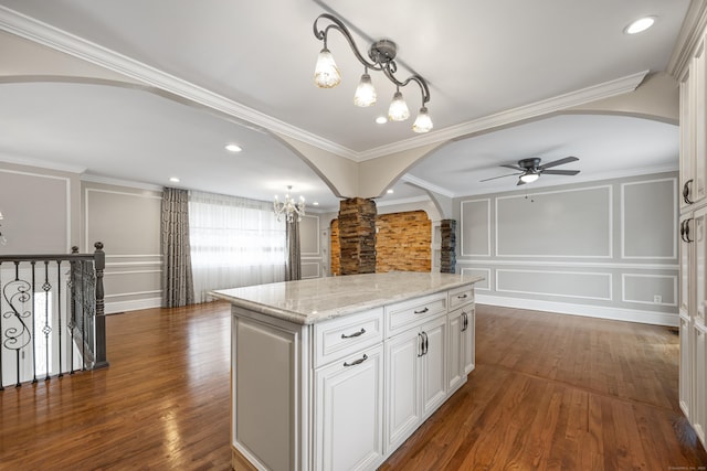 90 Haddad Rd, Waterbury, CT 06708 - kitchen featuring arched walkways, a decorative wall, ornate columns, a ceiling fan, and dark wood finished floors
