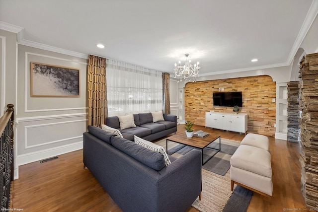 90 Haddad Rd, Waterbury, CT 06708 - living area featuring wood finished floors, a chandelier, crown molding, and recessed lighting