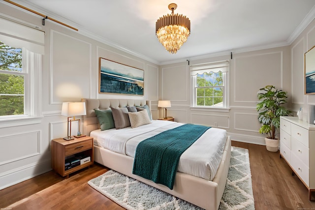 90 Haddad Rd, Waterbury, CT 06708 - bedroom with a decorative wall, a chandelier, crown molding, and wood finished floors