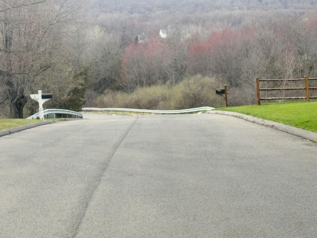 39 Ridge Blvd, East Granby, CT 06026 - view of asphalt road with curbs and a forest view