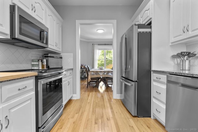 47 Bradford Walk Unit 47, Farmington, CT 06032 - kitchen featuring stainless steel appliances, white cabinets, tasteful backsplash, light wood-style flooring, and ornamental molding