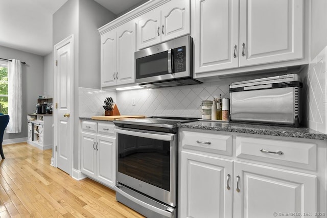 47 Bradford Walk Unit 47, Farmington, CT 06032 - kitchen featuring appliances with stainless steel finishes, white cabinets, tasteful backsplash, and light wood-type flooring