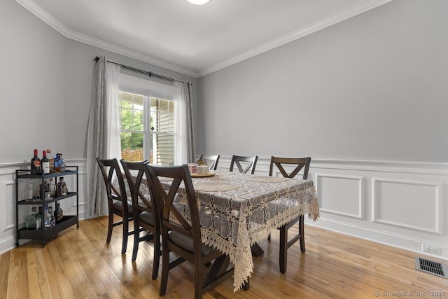 47 Bradford Walk Unit 47, Farmington, CT 06032 - dining space featuring a decorative wall, crown molding, light wood finished floors, and a wainscoted wall