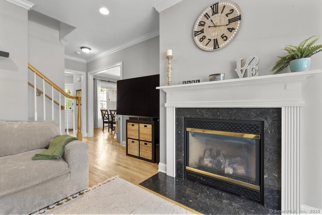 47 Bradford Walk Unit 47, Farmington, CT 06032 - living room featuring a premium fireplace, wood finished floors, crown molding, stairway, and recessed lighting