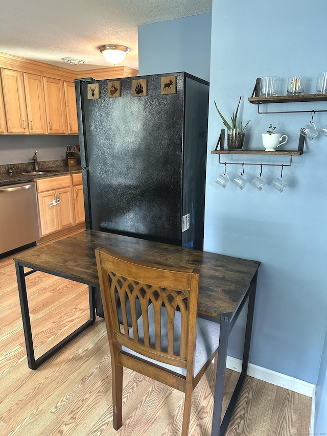 14 Lakeside Dr Unit Q, Ledyard, CT 06339 - kitchen featuring dishwasher, dark countertops, freestanding refrigerator, light wood-style floors, and a textured ceiling