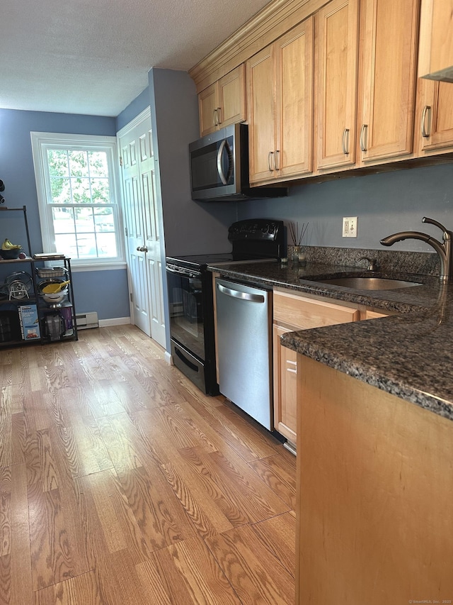 14 Lakeside Dr Unit Q, Ledyard, CT 06339 - kitchen with stainless steel appliances, light wood-type flooring, dark stone counters, and a textured ceiling