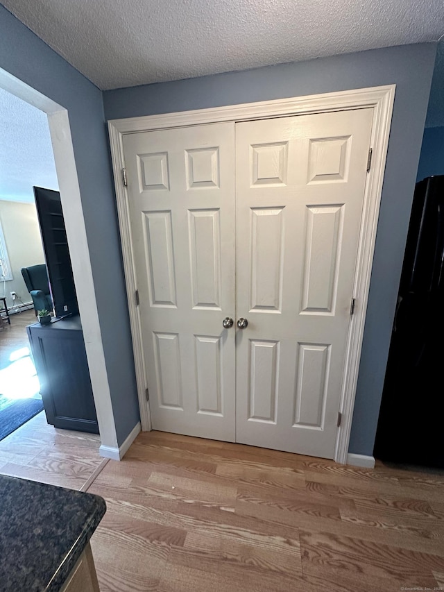 14 Lakeside Dr Unit Q, Ledyard, CT 06339 - detailed view of freestanding refrigerator, wood finished floors, and a textured ceiling