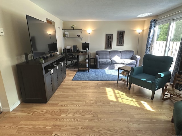 14 Lakeside Dr Unit Q, Ledyard, CT 06339 - living room with light wood-style flooring, a desk, and a textured ceiling