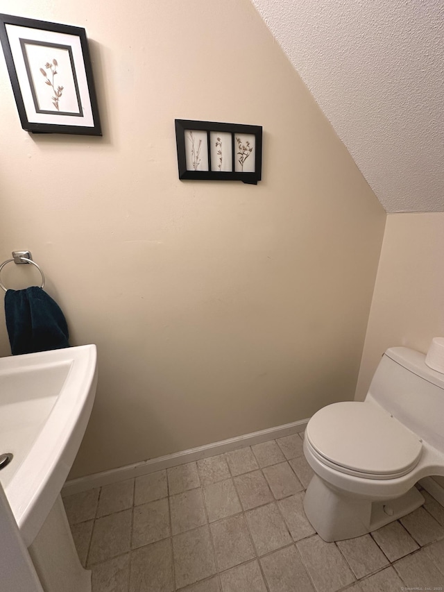 14 Lakeside Dr Unit Q, Ledyard, CT 06339 - half bathroom featuring a textured ceiling, lofted ceiling, and tile patterned flooring