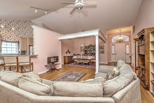 507 Elk Run Unit 507, Shelton, CT 06484 - living area with vaulted ceiling, a ceiling fan, track lighting, light wood-style flooring, and a chandelier