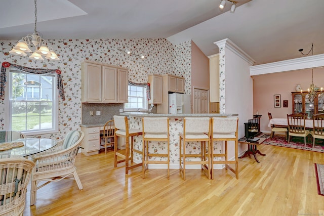507 Elk Run Unit 507, Shelton, CT 06484 - kitchen featuring a chandelier, light wood-type flooring, white fridge with ice dispenser, vaulted ceiling, and pendant lighting