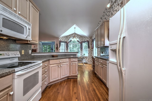 507 Elk Run Unit 507, Shelton, CT 06484 - kitchen featuring white appliances, vaulted ceiling, dark wood-type flooring, dark countertops, and a peninsula