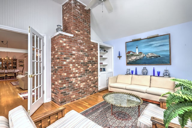 507 Elk Run Unit 507, Shelton, CT 06484 - living area with wood finished floors, a ceiling fan, high vaulted ceiling, built in shelves, and a chandelier