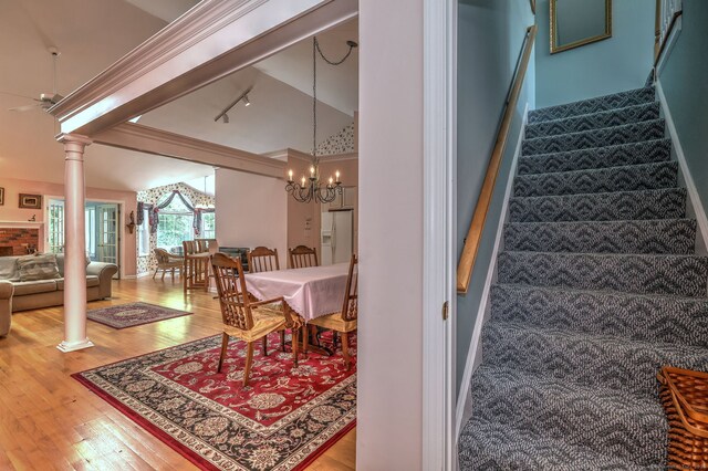 507 Elk Run Unit 507, Shelton, CT 06484 - stairway with wood finished floors, lofted ceiling, track lighting, a chandelier, and ornate columns