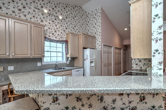 507 Elk Run Unit 507, Shelton, CT 06484 - kitchen with white appliances, vaulted ceiling, decorative backsplash, a peninsula, and a breakfast bar