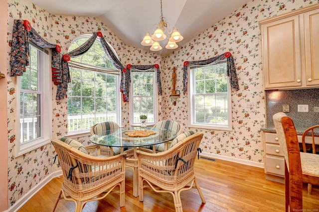 507 Elk Run Unit 507, Shelton, CT 06484 - dining area with a chandelier, light wood-style flooring, lofted ceiling, and wallpapered walls