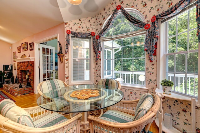 507 Elk Run Unit 507, Shelton, CT 06484 - dining area with wallpapered walls, wood finished floors, a fireplace, and lofted ceiling