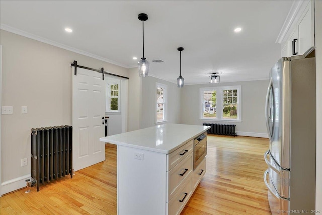 502 Adams St, Manchester, CT 06040 - kitchen with appliances with stainless steel finishes, radiator, ornamental molding, light countertops, and white cabinetry
