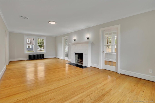 502 Adams St, Manchester, CT 06040 - unfurnished living room featuring radiator heating unit, light wood-style flooring, a fireplace with flush hearth, and ornamental molding