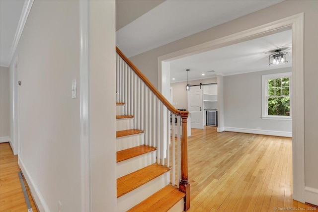 502 Adams St, Manchester, CT 06040 - staircase with hardwood / wood-style floors, a barn door, ornamental molding, and recessed lighting
