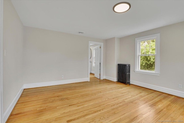 502 Adams St, Manchester, CT 06040 - empty room with radiator and wood finished floors