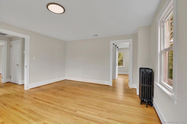 502 Adams St, Manchester, CT 06040 - unfurnished room with radiator heating unit and light wood-style floors