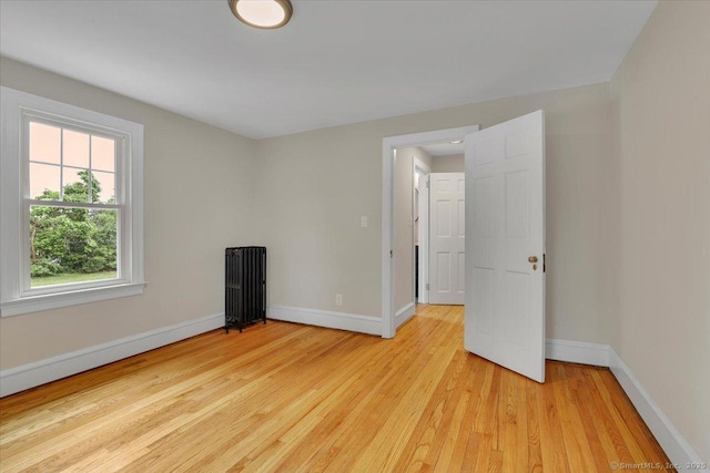 502 Adams St, Manchester, CT 06040 - unfurnished room with light wood-type flooring and radiator