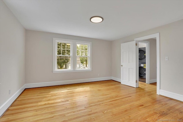 502 Adams St, Manchester, CT 06040 - spare room with estacked washer and dryer and light wood-style floors