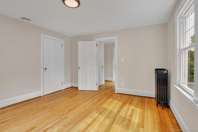 502 Adams St, Manchester, CT 06040 - unfurnished bedroom featuring radiator and wood finished floors