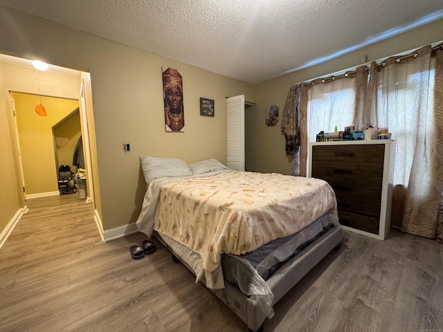 1485 Corbin Ave, New Britain, CT 06053 - bedroom with wood finished floors and a textured ceiling