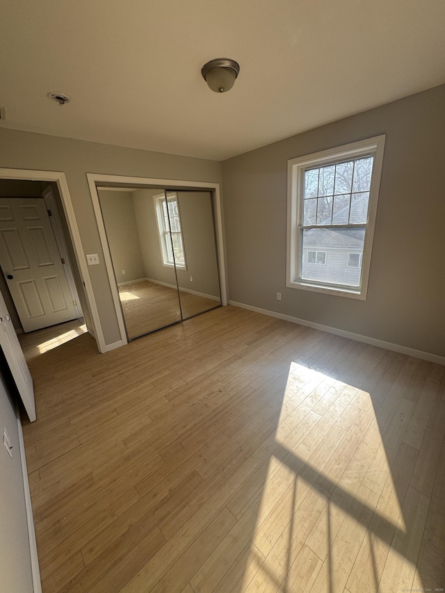 28 Devon Dr, Manchester, CT 06040 - unfurnished bedroom featuring wood finished floors and a closet