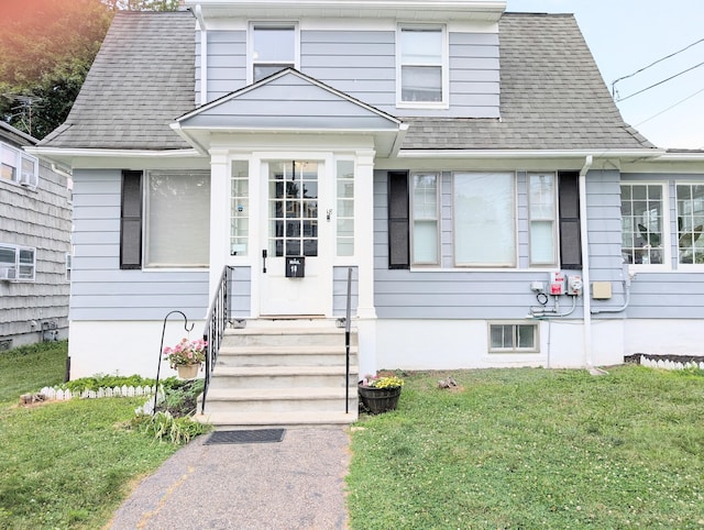 18 Victory St, Bridgeport, CT 06606 - view of front of house with roof with shingles and a front yard