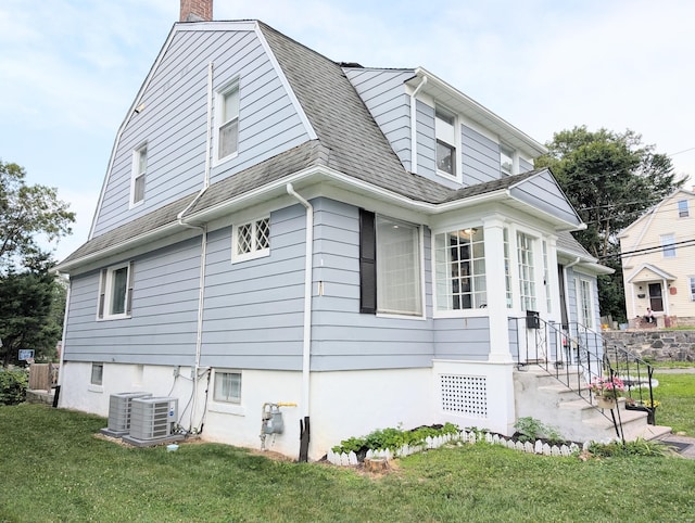 18 Victory St, Bridgeport, CT 06606 - view of side of home with a chimney, a lawn, and roof with shingles