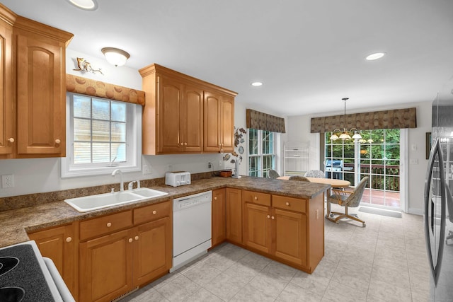 16 Spinnaker Dr Unit 16, East Lyme, CT 06357 - kitchen with dishwasher, a peninsula, hanging light fixtures, recessed lighting, and freestanding refrigerator