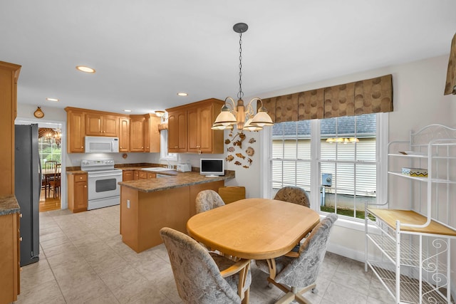 16 Spinnaker Dr Unit 16, East Lyme, CT 06357 - kitchen featuring white appliances, a peninsula, a chandelier, decorative light fixtures, and recessed lighting