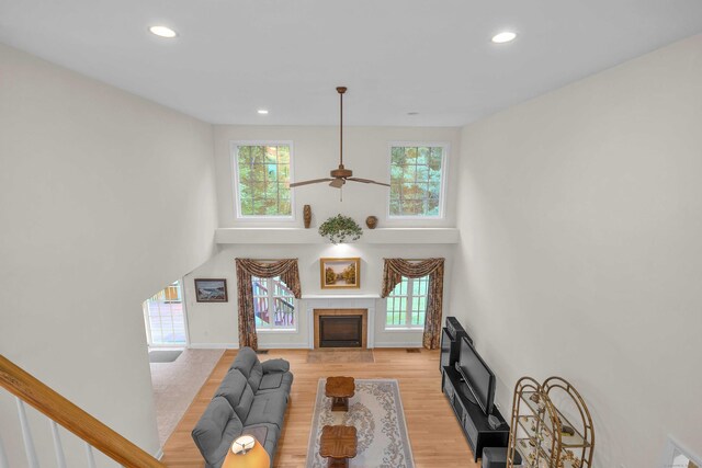 16 Spinnaker Dr Unit 16, East Lyme, CT 06357 - living room with a high ceiling, recessed lighting, light wood-style flooring, a fireplace, and ceiling fan