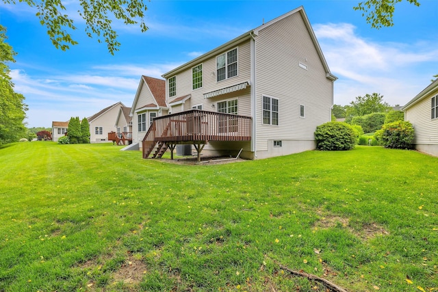 16 Spinnaker Dr Unit 16, East Lyme, CT 06357 - rear view of house with a wooden deck and a lawn