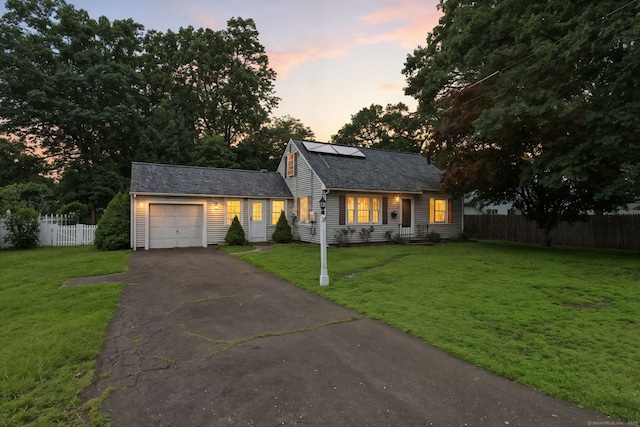 17 Wilstar Cir, Enfield, CT 06082 - view of front facade featuring an attached garage, asphalt driveway, and roof mounted solar panels