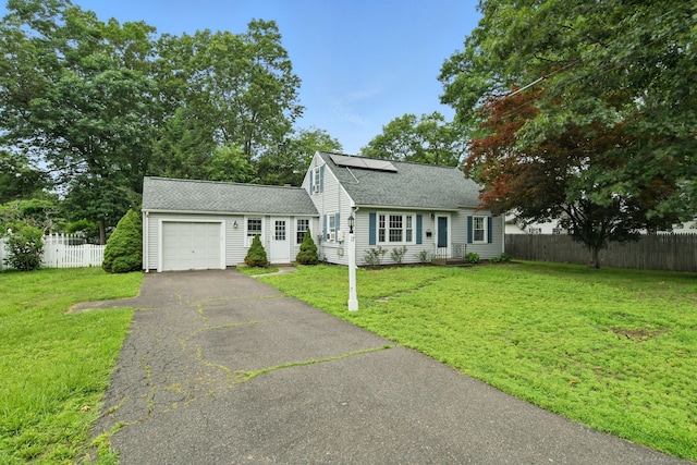 17 Wilstar Cir, Enfield, CT 06082 - view of front of home featuring an attached garage, solar panels, roof with shingles, and driveway