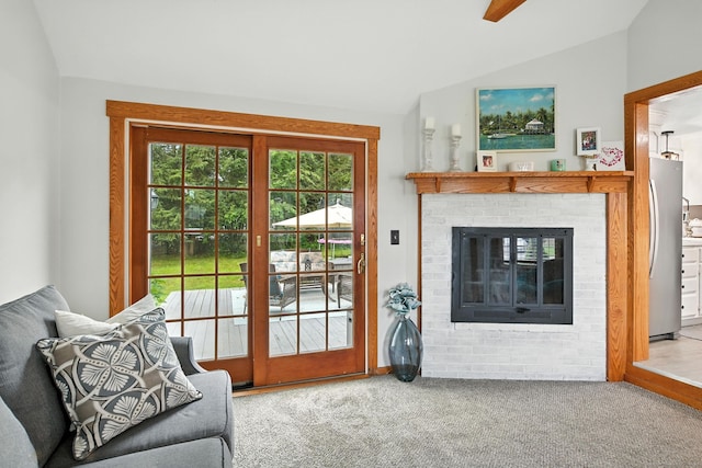 17 Wilstar Cir, Enfield, CT 06082 - carpeted living room with lofted ceiling and a brick fireplace