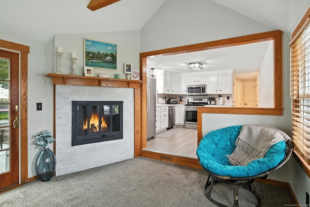 17 Wilstar Cir, Enfield, CT 06082 - living room featuring lofted ceiling, a fireplace, and light carpet