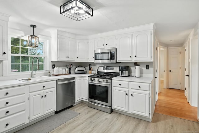 17 Wilstar Cir, Enfield, CT 06082 - kitchen with stainless steel appliances, light wood-style floors, white cabinets, and light countertops