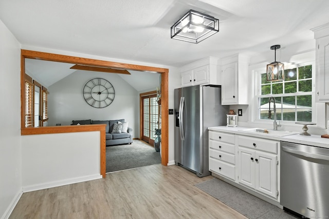 17 Wilstar Cir, Enfield, CT 06082 - kitchen with stainless steel appliances, light wood-style floors, white cabinetry, light countertops, and open floor plan